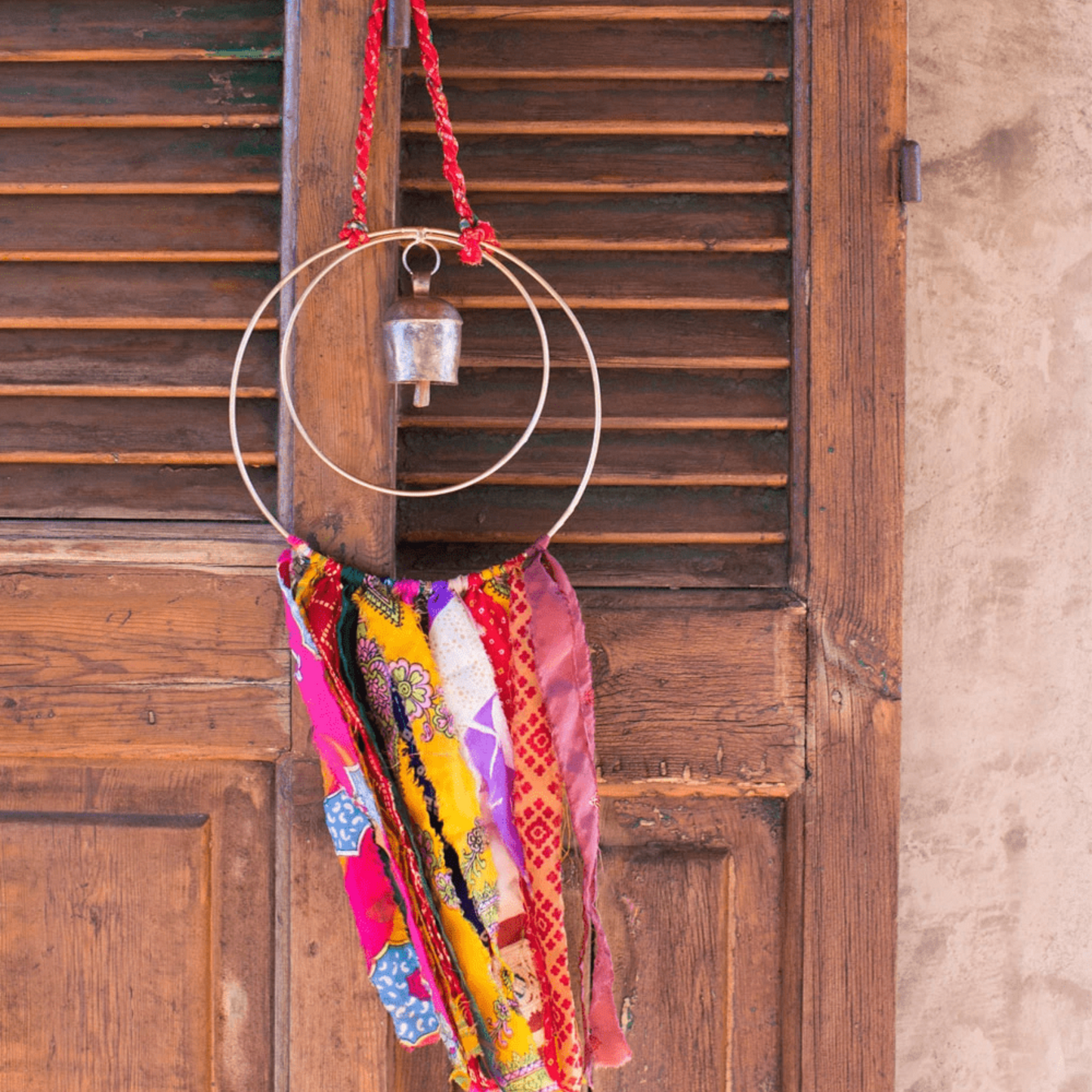 Surya Circle Chime with Rustic Bell - Metal, Assorted Cloth Tassels, Handmade, Twisted sari hanging loop - Aksa Home Decor