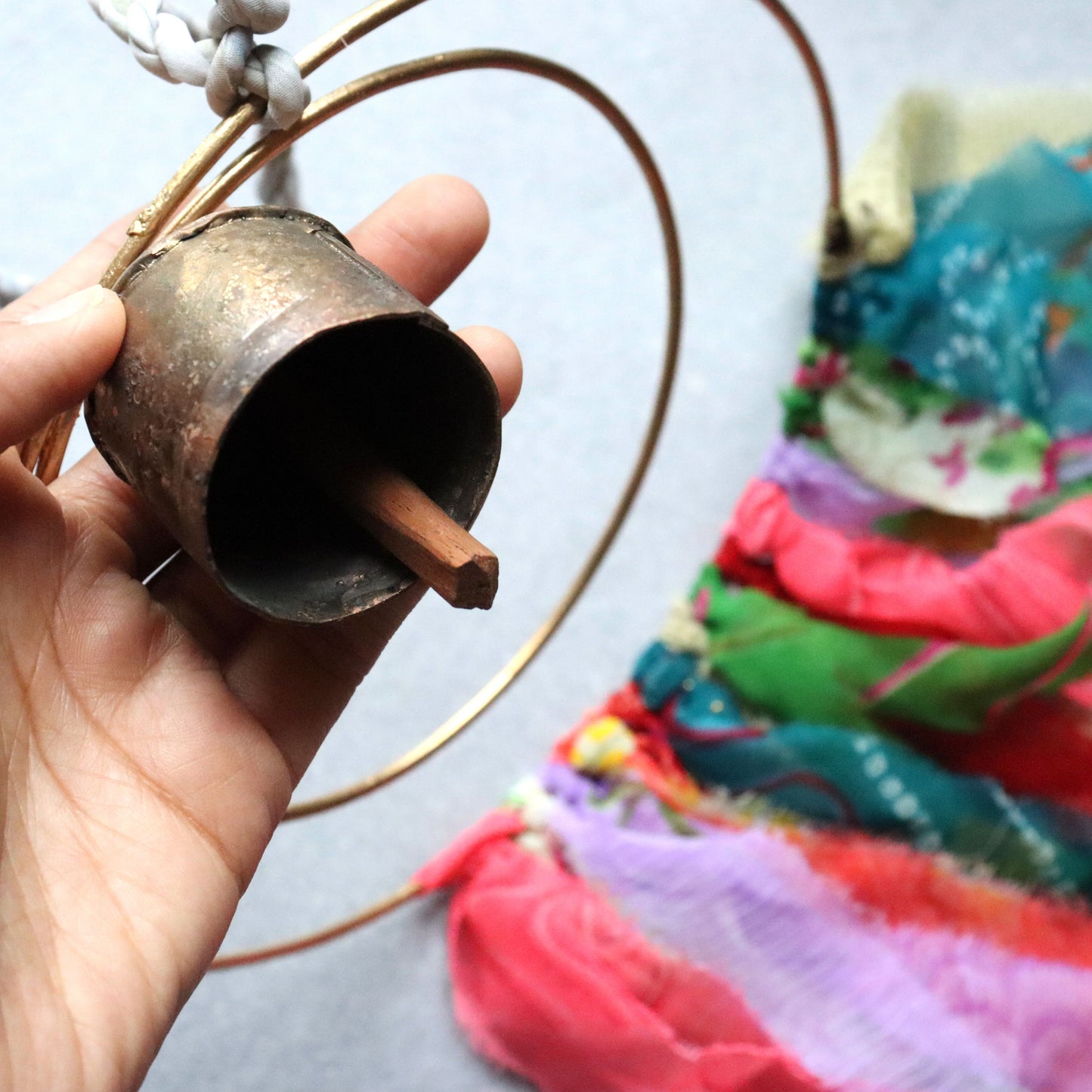 Surya Circle Chime with Rustic Bell - Metal, Assorted Cloth Tassels, Handmade, Twisted sari hanging loop - Aksa Home Decor